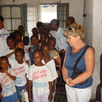 The children are showing the tourists around in the orphanage